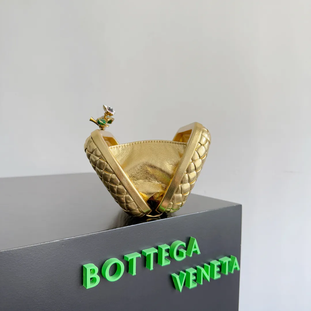 Batch 2100 BOTTEGA VENETA Women's Knot Evening Bag. An evening bag as beautiful as a jewelry box. Sharp-eyed friends must have discovered that the leather this time has a metallic luster. The whole bag looks very high-end. Even in a low-light environment, it is difficult to hide the excellent gloss of this bag. The three-dimensional flower made of brass will not oxidize. It is a heavy workmanship visible to the naked eye. Style number: 826183 (717622) Color: gold Size: 19*11.5*5cm
